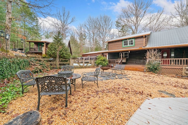 view of yard featuring a wooden deck and an outdoor fire pit