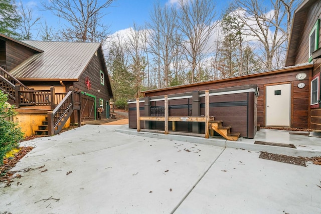 exterior space with a jacuzzi, a patio, and a deck