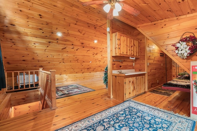 additional living space featuring wood ceiling, wooden walls, and wood-type flooring