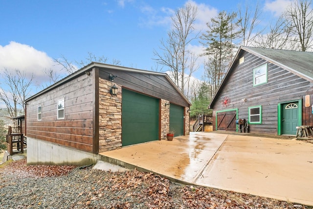 view of side of home featuring a garage