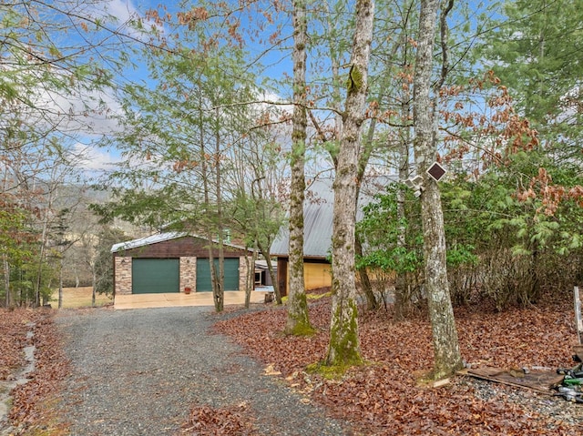 single story home with a garage and an outdoor structure