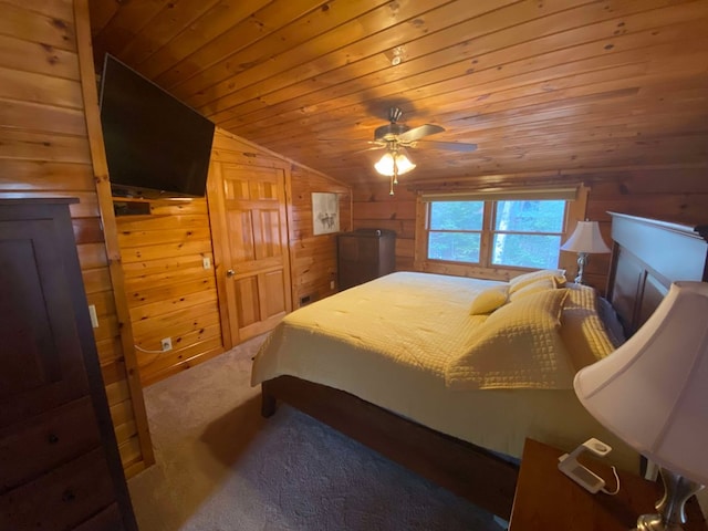 carpeted bedroom with ceiling fan, lofted ceiling, wood ceiling, and wooden walls