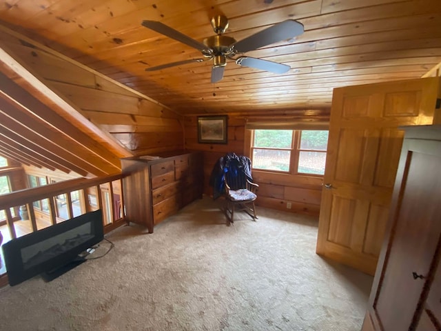 interior space featuring wood ceiling, wooden walls, light colored carpet, and vaulted ceiling