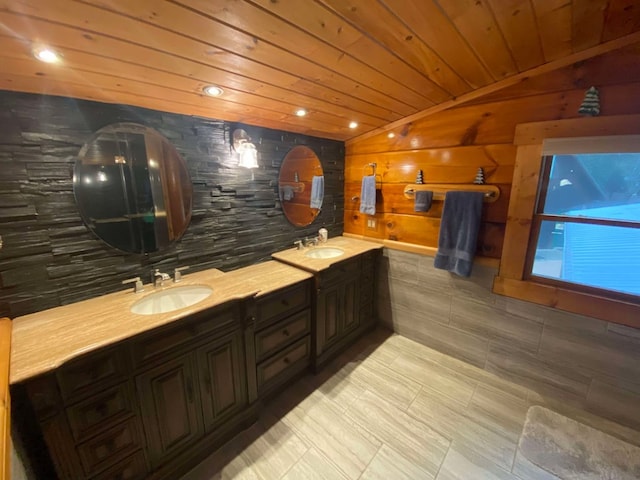 bathroom with vaulted ceiling, wooden walls, vanity, and wood ceiling