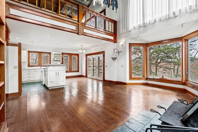 198 Hollow Log Trl, Ellijay, GA 30536 - unfurnished living room with a chandelier, baseboards, dark wood-style flooring, and recessed lighting