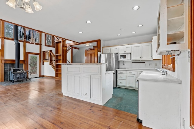 198 Hollow Log Trl, Ellijay, GA 30536 - kitchen with white microwave, a sink, recessed lighting, plenty of natural light, and white cabinetry