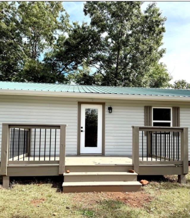 exterior space featuring a deck and metal roof