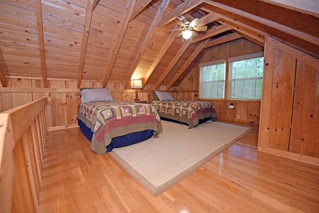 bedroom featuring wood walls, wood finished floors, vaulted ceiling with beams, and wooden ceiling