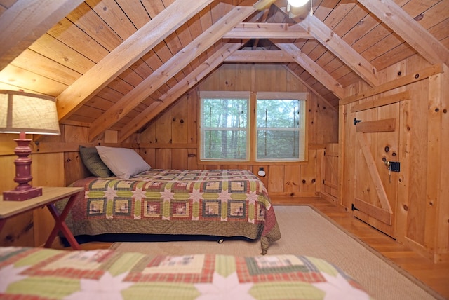 bedroom with lofted ceiling with beams, wood finished floors, and wood ceiling