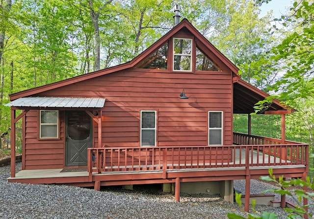 back of house with a deck