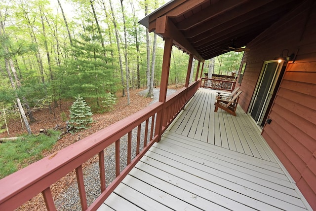 wooden deck with a ceiling fan
