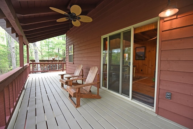 wooden deck featuring a ceiling fan