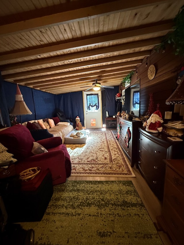 interior space featuring beamed ceiling, ceiling fan, and wood ceiling