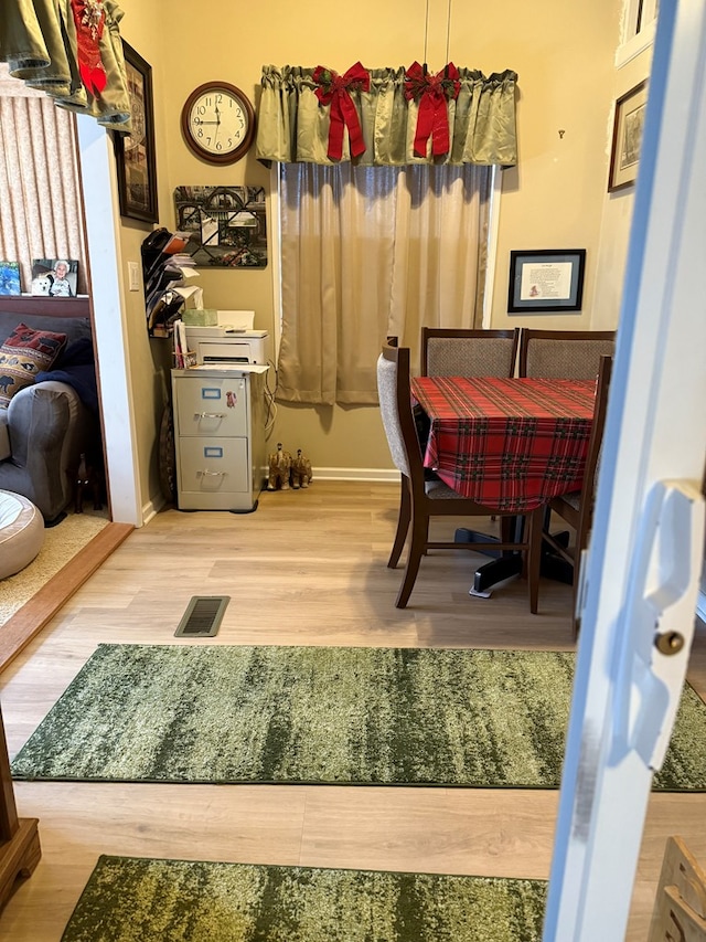 dining space with light hardwood / wood-style floors