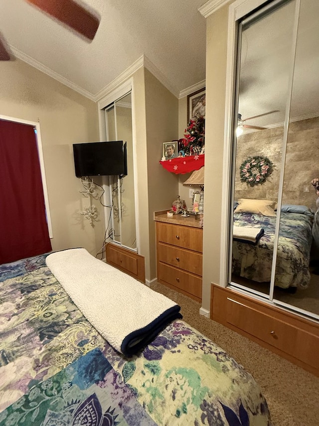 bedroom with carpet flooring, ceiling fan, crown molding, a closet, and lofted ceiling