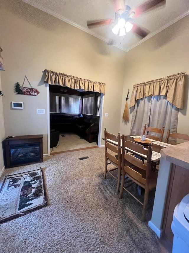 bedroom with dark colored carpet, ceiling fan, crown molding, and a textured ceiling