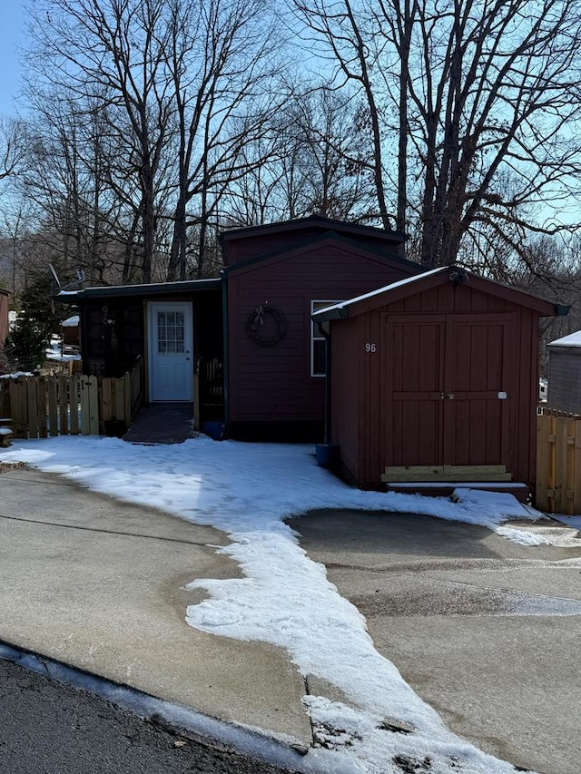 96 Stag Leap Dr, Cleveland, GA 30528 - snow covered structure with a storage unit, an outdoor structure, and fence