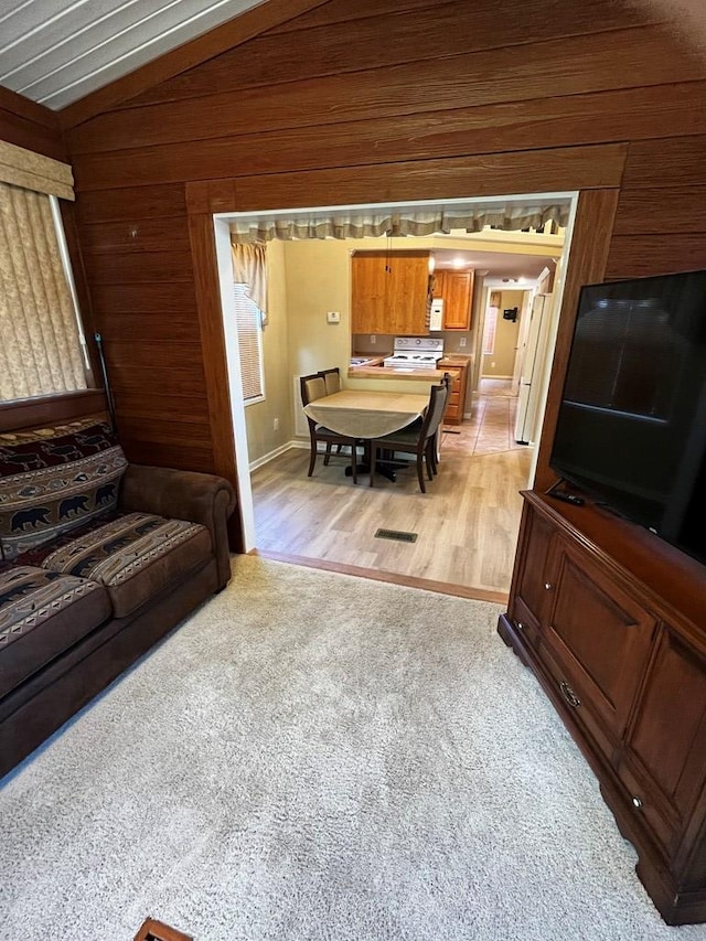 96 Stag Leap Dr, Cleveland, GA 30528 - living area featuring wooden walls, light carpet, light wood-type flooring, and lofted ceiling