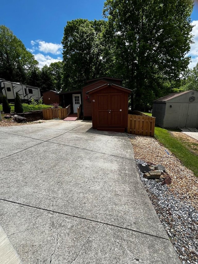 96 Stag Leap Dr, Cleveland, GA 30528 - garage with a storage unit, fence, and concrete driveway