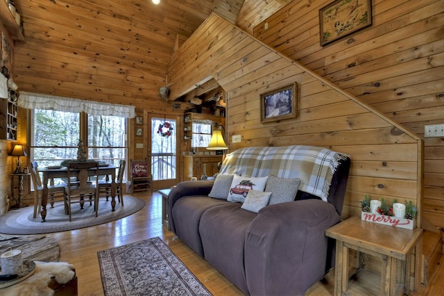 living area with wood-type flooring, high vaulted ceiling, wood ceiling, and wood walls