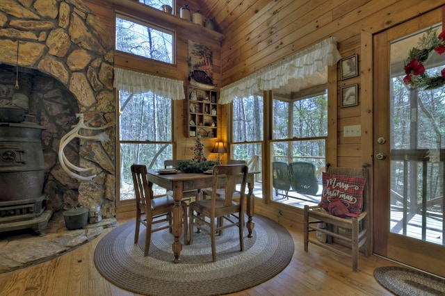 dining space with a wealth of natural light, wood-type flooring, and high vaulted ceiling