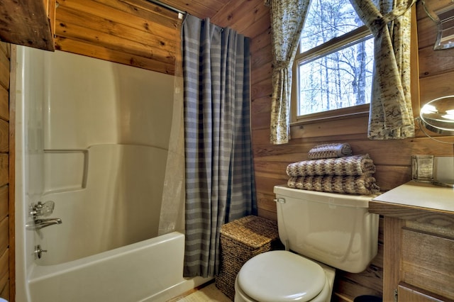 full bath featuring vanity, toilet, shower / bath combo, and wood walls