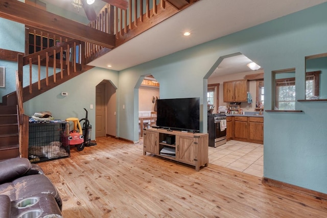 432 Jewell Mason, Blairsville, GA 30512 - living room with light wood-style flooring, stairs, arched walkways, and a ceiling fan