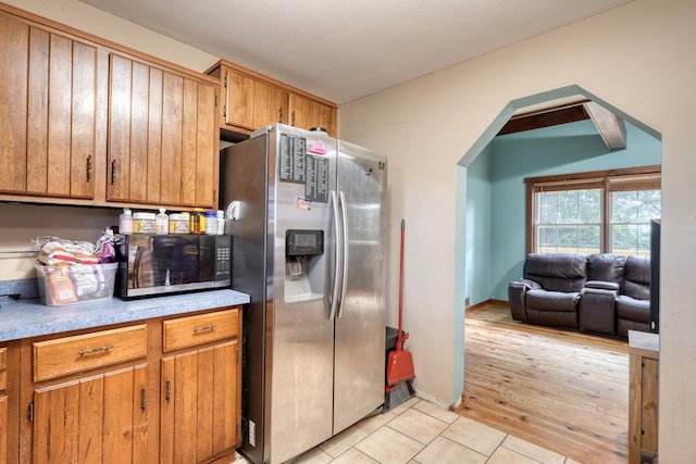 432 Jewell Mason, Blairsville, GA 30512 - kitchen with stainless steel fridge, light tile patterned flooring, brown cabinetry, and light countertops