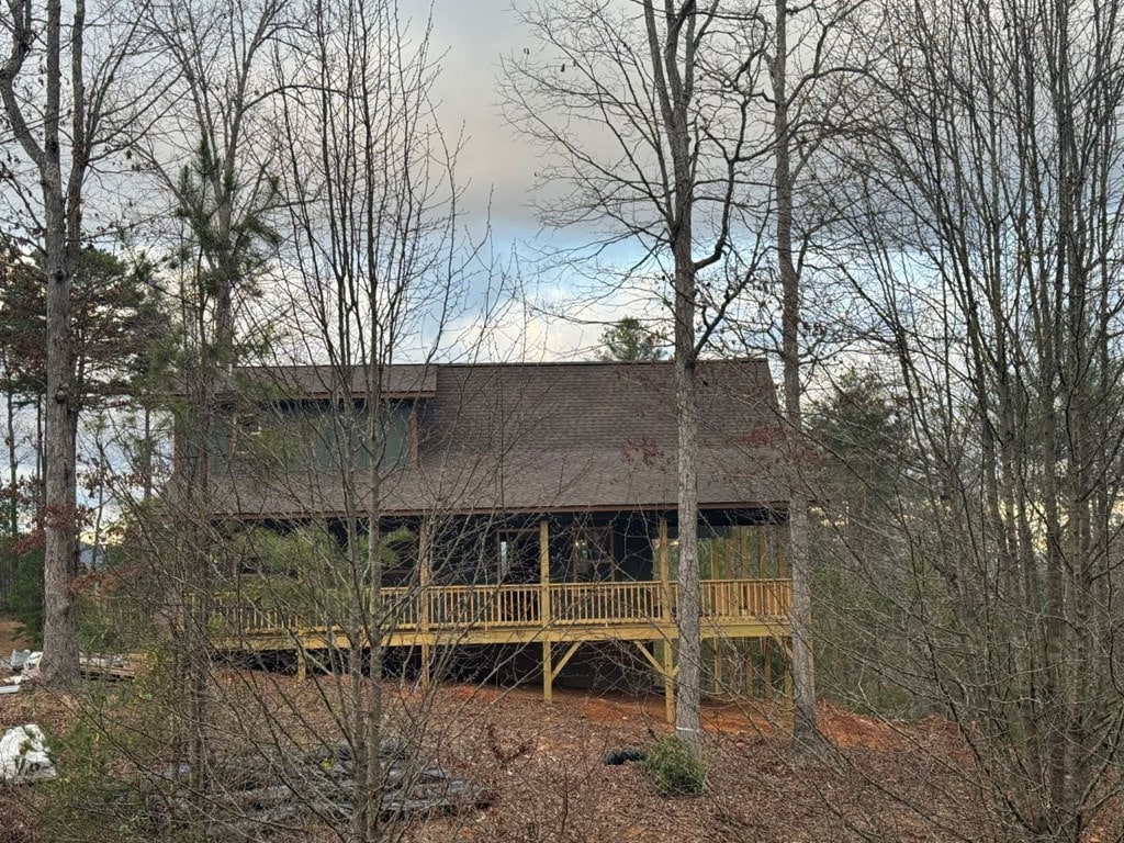 back of house featuring a wooden deck