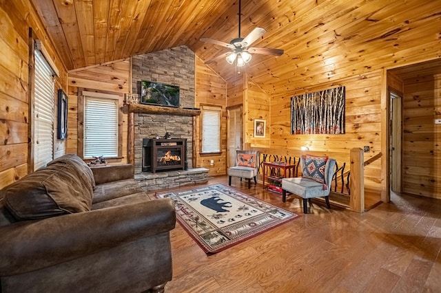 living area featuring high vaulted ceiling, wood ceiling, wooden walls, and hardwood / wood-style floors