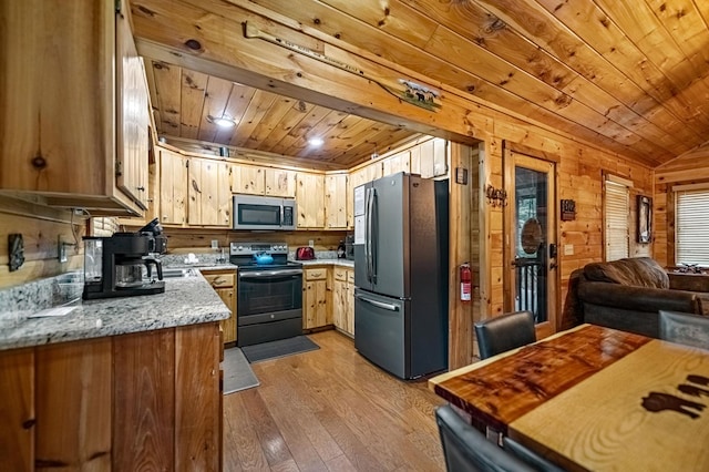 kitchen featuring open floor plan, stainless steel appliances, light wood finished floors, and wood ceiling