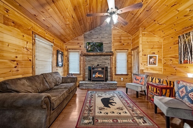 living room featuring a stone fireplace, wood-type flooring, wood ceiling, and wooden walls