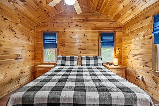 unfurnished bedroom featuring wood ceiling, multiple windows, vaulted ceiling, and wooden walls