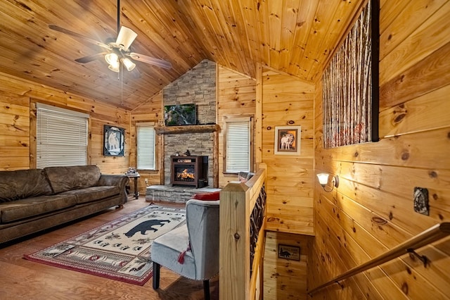 living area featuring a fireplace, lofted ceiling, wood ceiling, wooden walls, and wood finished floors