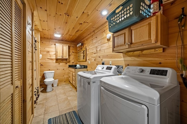 laundry room with washer and dryer, wood ceiling, wooden walls, and light tile patterned floors