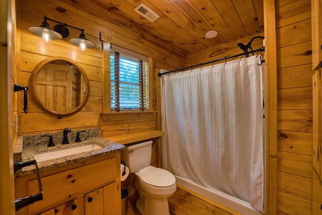 full bathroom featuring shower with separate bathtub, toilet, wooden walls, and vanity