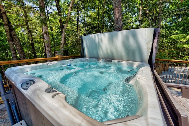 view of swimming pool with a hot tub