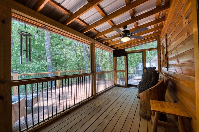 sunroom / solarium with ceiling fan and lofted ceiling with beams