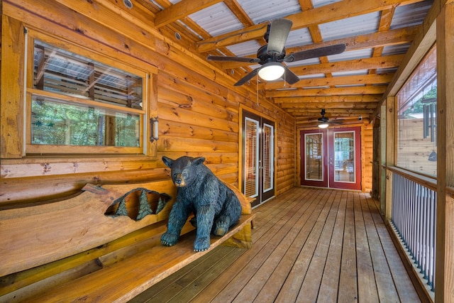 sunroom / solarium featuring ceiling fan, beam ceiling, and french doors