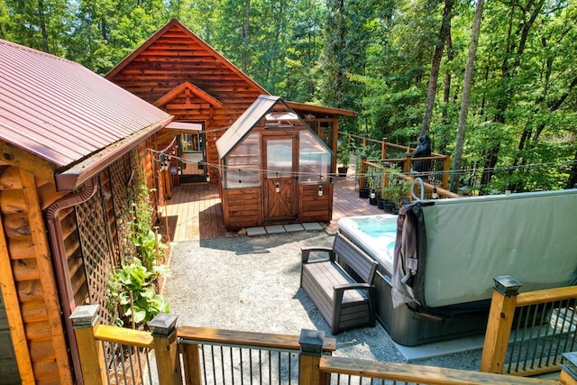 deck featuring a hot tub and a patio