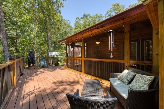 deck featuring outdoor lounge area and a sunroom