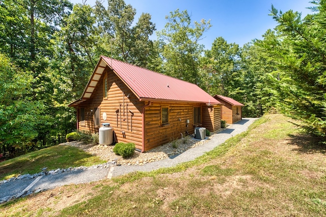 view of side of home featuring a yard and central air condition unit