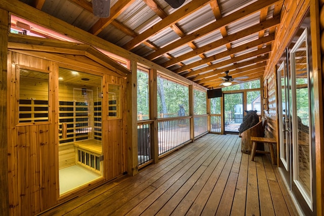 unfurnished sunroom featuring wood ceiling, plenty of natural light, vaulted ceiling, and ceiling fan