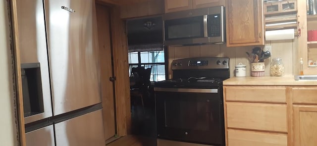 kitchen featuring light brown cabinetry and stainless steel appliances