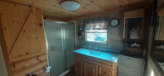 bathroom with walk in shower, wood ceiling, wooden walls, and sink