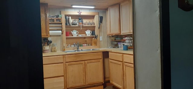 kitchen featuring light brown cabinetry, wooden ceiling, and sink