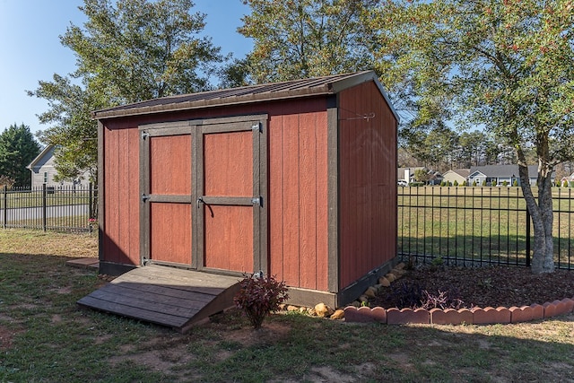 view of outbuilding featuring a lawn