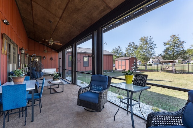 sunroom with ceiling fan, wood ceiling, and vaulted ceiling