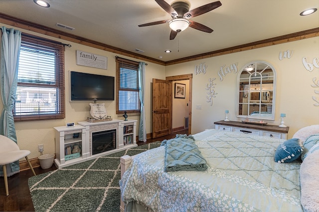 bedroom featuring a textured ceiling, dark hardwood / wood-style flooring, ceiling fan, and crown molding