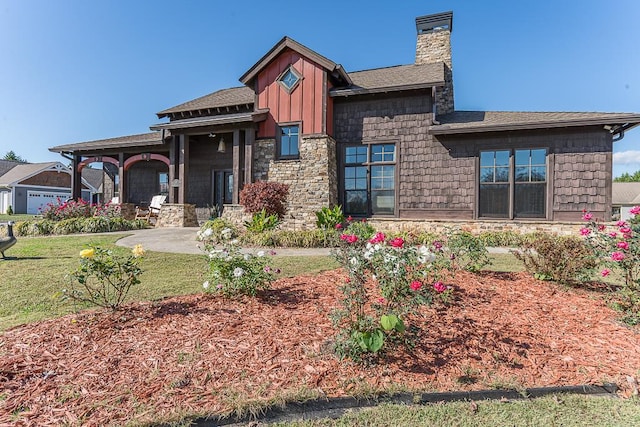 45 Bent Grass Cir, Hayesville, NC 28904 - view of front of house with a chimney, stone siding, a front lawn, roof with shingles, and board and batten siding